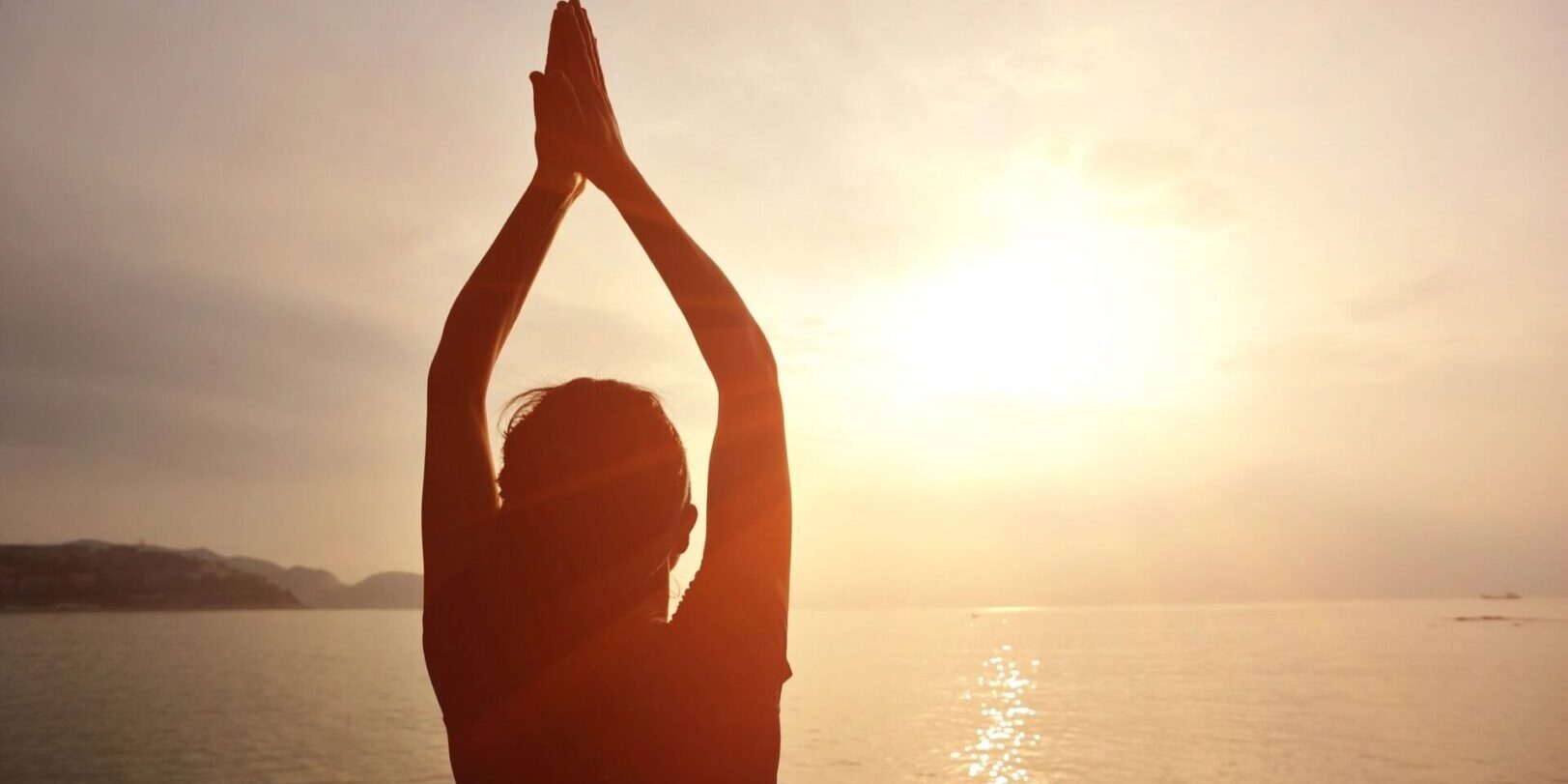 A person standing in the air with their hands raised.